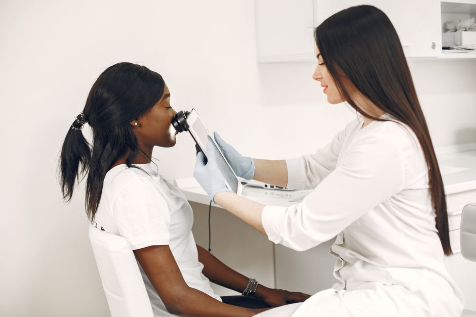 A dermatologist examining a patient's skin